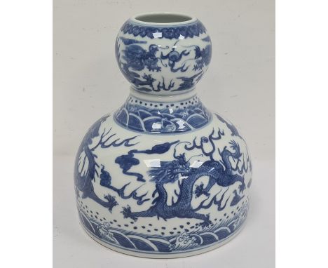 Chinese porcelain double-gourd vase with broad flat base and underglaze blue decoration of dragons and waves, seal mark to ba