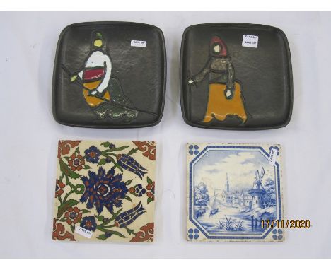Pair of 20th century Turkish pottery plates by Gorbon Isil, each of square form depicting hooded figures, 18cm square, a Vill