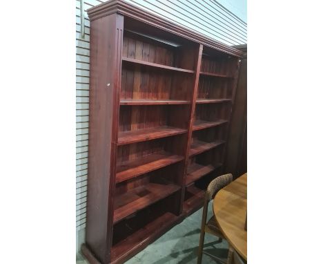 Large stained pine open bookcase, the moulded cornice above assorted shelves, on squat bracket feet, 202cm x 197.5cmCondition