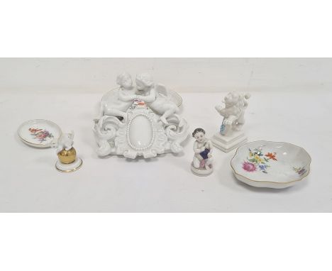 Meissen white porcelain cherub group, damaged, Nymphenburg porcelain lion with shield, Rosenthal cat and four other porcelain