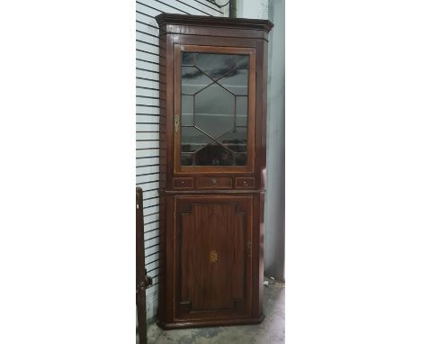 19th century mahogany corner cabinet, the cavetto moulded cornice above astragal glazed door, enclosing shelf, three drawers 