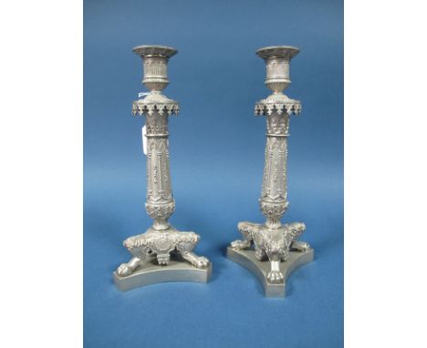 A Pair of Plated Candlesticks, each column with Gothic Arch style decoration in relief, with removable nozzles, on three paw 