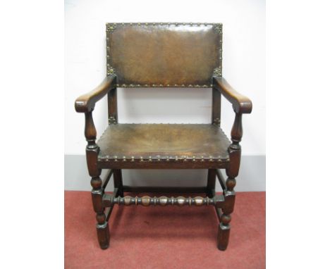 A Set of Six XVII Century Style Oak Dining Chairs, with leather seats and back panel, stud decoration, on turned and block su