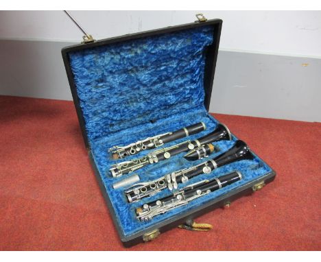 A Triebert Rosewood Clarinet, No. 2223 ALP; A Boosey & Hawkes "Regent" Plastic Clarinet, both in fitted case. (2)
