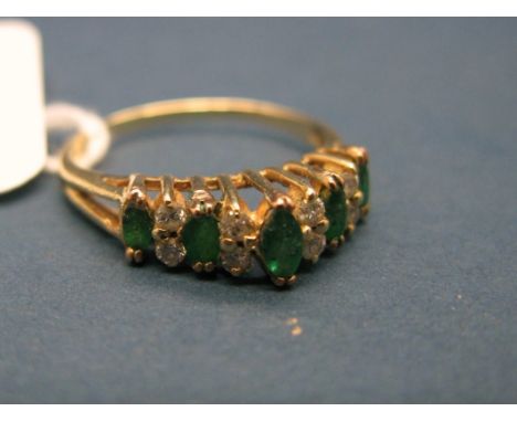 An Emerald and Diamond Set Ring, of high stepped design, claw set throughout. 