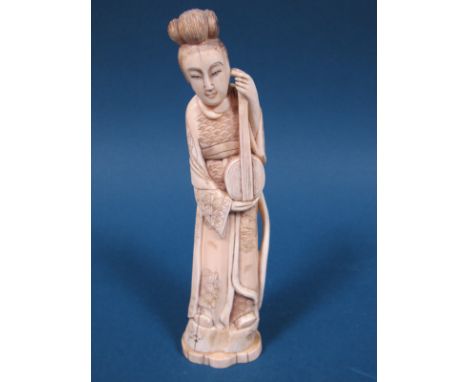 A Late XIX Century Japanese Ivory Figure of a Lady, in traditional costume, holding a lute and standing on a rock, shaped ova