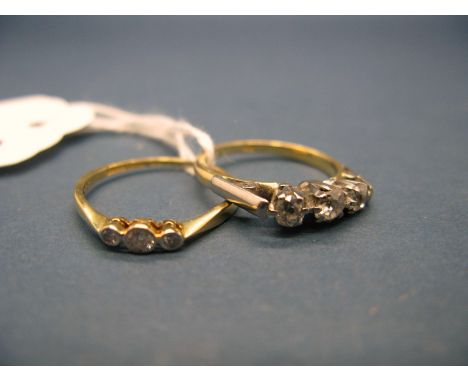 A Three Stone Diamond Ring, claw set with graduated old cut stones, indistinctly stamped; Together with Another Three Stone R