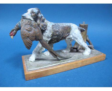 A Cold Painted Soft Metal Table Lighter, circa 1920's, in the form of a retriever spaniel with game seated beside a tree trun