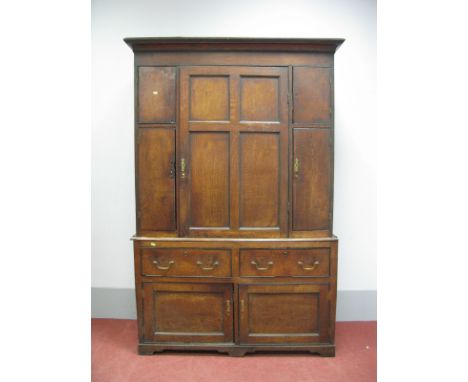 An XVIII Century Oak Cupboard, the top with stepped cornice and five panelled cupboard doors above two small drawers and two 