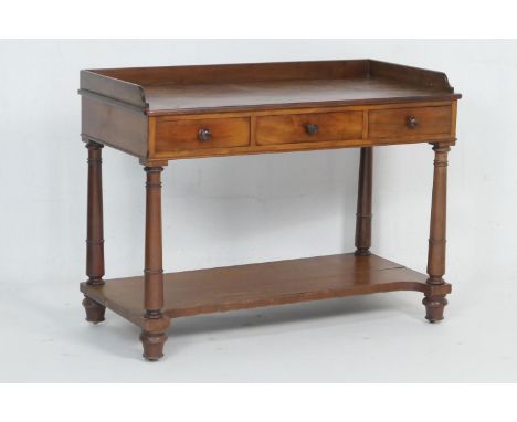Early Victorian mahogany washstand, circa 1840, three quarter gallery top with three frieze drawers with turned wooden knobs,