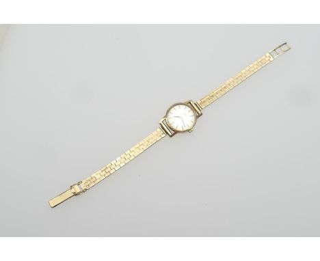 Omega 9ct gold lady's bracelet wristwatch, 17mm dial with baton numerals, manual wind, on a 9ct gold brick link bracelet, len