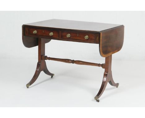 Late Regency mahogany sofa table, circa 1820, the crossbanded top with drop leaves over two frieze drawers with brass knobs, 