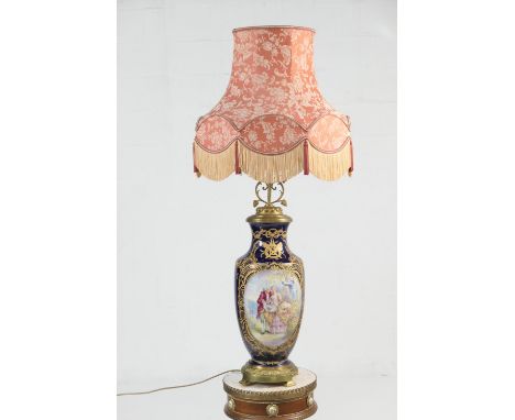 Sevres style hand decorated porcelain vase lamp, with brass mounts and decorated with gilded panels featuring a chateau and c