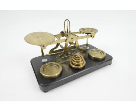 Sampson Mordan &amp; Co., London, brass postal scales, with weights, on an ebonised mahogany base, 27cm (Please note conditio