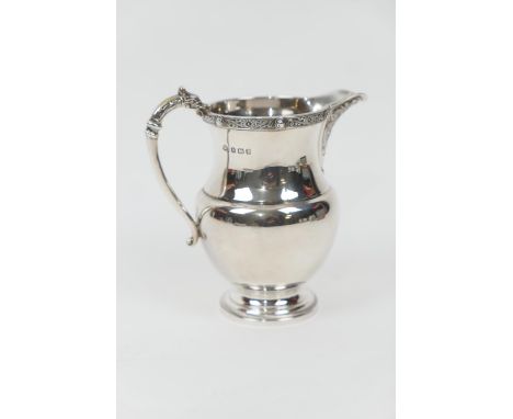 George V silver cream jug, by the Adie Bros., Birmingham 1935, baluster form with Celtic inspired details to the spout, rim a
