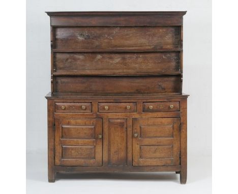 George II oak enclosed dresser and plate rack, North Wales, circa 1720-40, boarded rack with ogee moulded cornice, over a bas