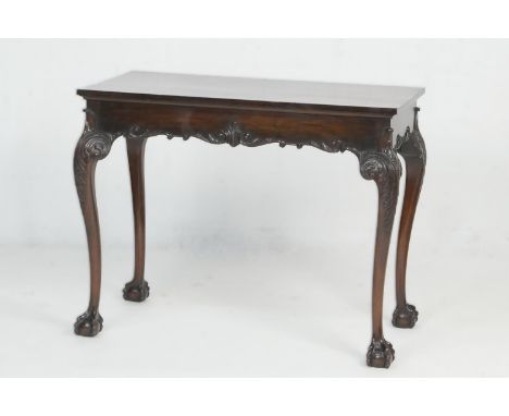 Mahogany side table in the Chippendale style, circa 1900, the rectangular top over a frieze with carved edge, raised on acant