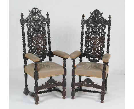 Pair of Victorian heavily carved ebonised oak armchairs, in 17th Century style, with light brown floral tapestry stuffover se