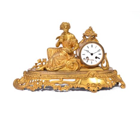 A French gilt bronze mantel clock crowned with a lady holding doves in her hand, 19th C.H 27 - L 46,5 - D 15,5 cm  The work m