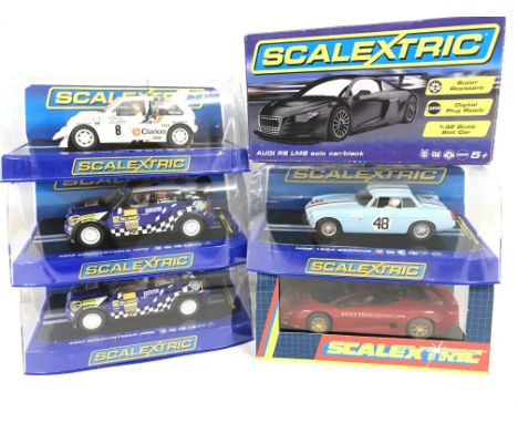 6 X Boxed Scalextric Cars. A MG Metro 6R4. 2 X Mini Countryman WRC. A Audi R8 LMS Solo Car. A MGB 1964 Searing and a Jaguar X