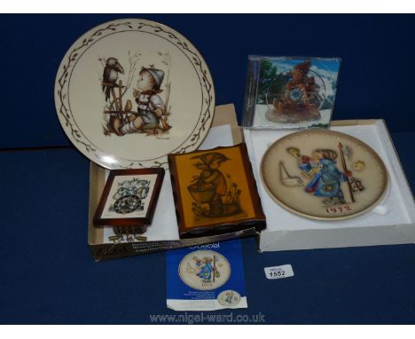 A framed miniature clock, a wooden plaque and Hummel annual plates