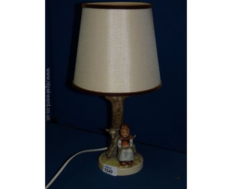 A Hummel Table Lamp and shade with a girl and a lamb to the base