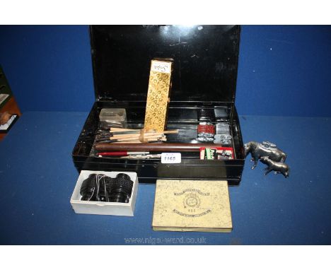 An old tin deed Box with miscellaneous pens, table lighter in the form of a mare and foal, propelling pencil, etc