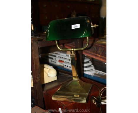 A Brass desk Lamp with green glass shade