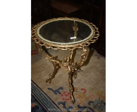 A gilded/gold coloured finish metal framed tripod occasional table having a drop-in circular glass top 18" diam. approx.