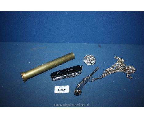 An Acme Whistle on chain, a Swiss Army Knife and a small brass part from a telescope