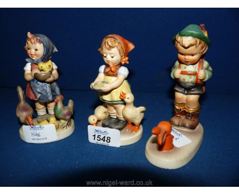 Three Hummel figures; Girl with mother hen and chicks, a Boy with rabbit and a Girl with ducks