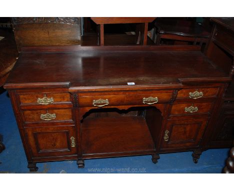 A late 19th c. breakfront Walnut Sideboard having central carved front drawer over dog kennel, flanked by two short drawers o