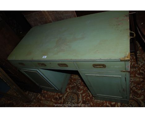 A military style Kneehole Desk in green painted finish, three frieze drawers with recessed brass handles, over single panel d