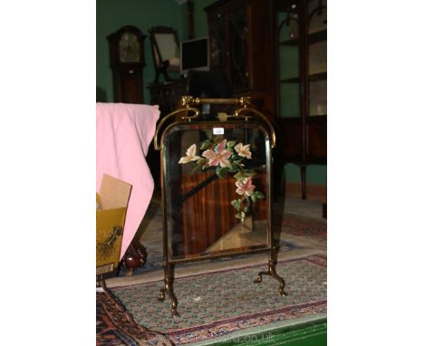 An Edwardian brass and painted Mirror Fire Screen
