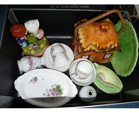 A quantity of china including Carltonware leaf shaped sauce boat and saucer, cottage ware biscuit barrel, oval trays, etc.