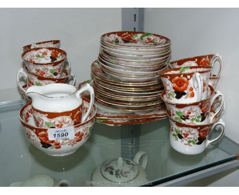 An Edwardian part Teaset in orange and blue including two bread and butter plates, eleven side plates, twelve cups, eleven sa