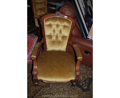 A 19th c. Walnut show frame Salon Armchair, carved frame and arm supports, on turned and fluted legs, in gold button back dra