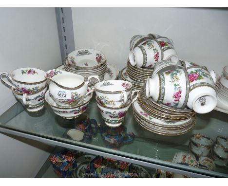 A part Paragon Teaset 'Tree of Kashmir' pattern comprising twelve cups, thirteen saucers, nine plates, sugar bowl, and milk j