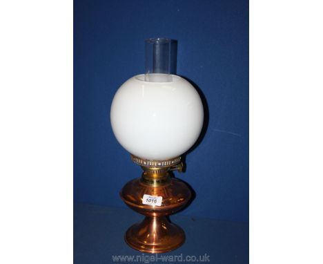 A Brass and copper Oil Lamp with white shade and funnel