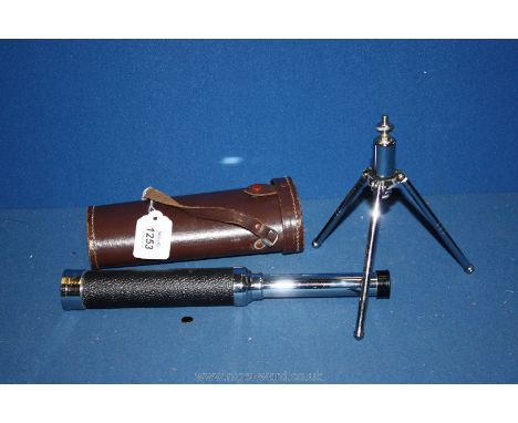 A three draw Telescope complete with tripod in a leather carrying case