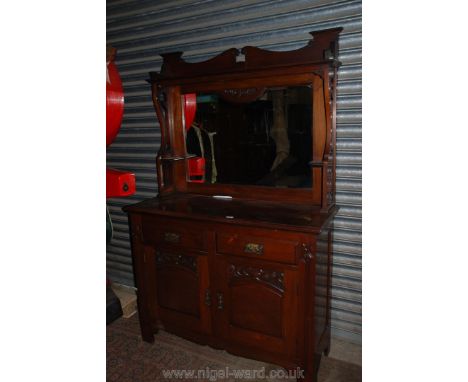 An art nouveau Chestnut mirrorback Sideboard having ornately framed bevel plated mirror back over moulded top, two frieze dra