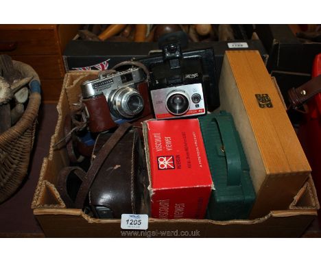 A slide viewer and miscellaneous slides, a Polaroid camera, Kodak colorsnap 35 camera, Voigtlander Vito BL camera, Cine camer