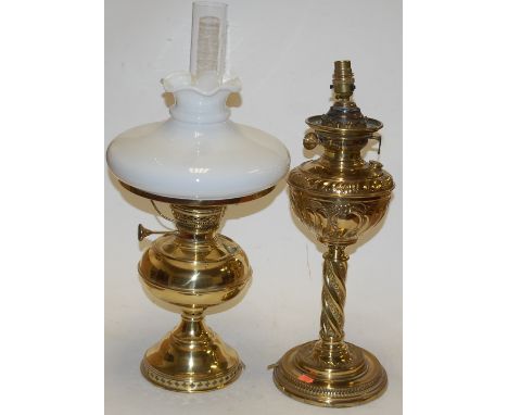 An early 20th century LiteNite German brass pedestal oil lamp, having opalescent glass shade; together with one other Victori