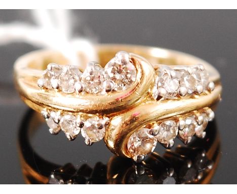An 18ct gold diamond set dress ring, arranged as two rows of seven graduated brilliants, size K-