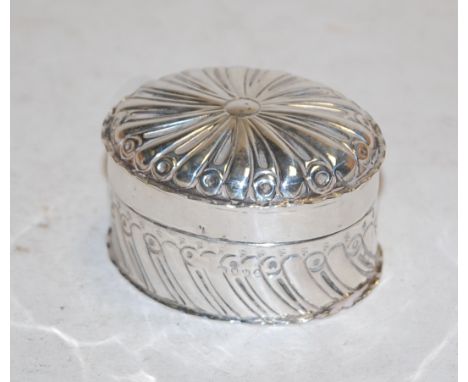 A Victorian silver trinket jar and cover, having all-over repousee decoration 