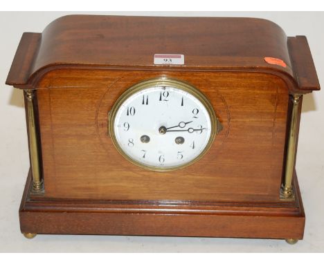 An Edwardian mahogany cased mantel clock having an enamel dial with Arabic numerals and eight day movement striking on a gong