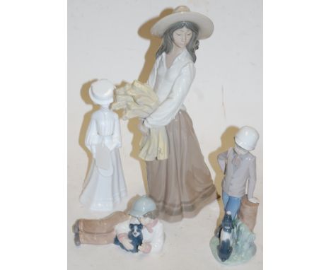 A large Nao figure modelled as a girl in a hat with armful of wheat; together with two other Nao figures of boys with dogs; a