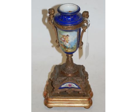 A late 19th century continental porcelain gilt metal mounted urn, the central panel depicting seated maidens, on a gilt wood 