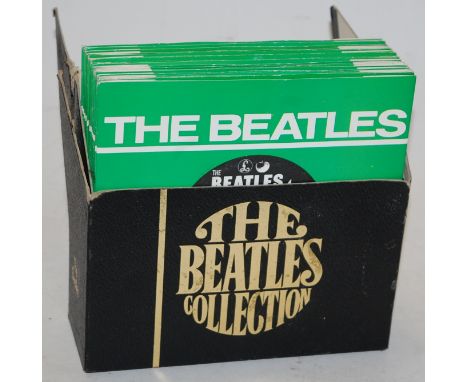 A boxed set - The Beatles Collection 7" records together with a Beatles zippo lighter