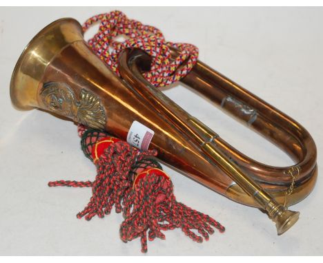 A copper and brass bugle bearing a label for the 23rd Royal Welsh Fusiliers